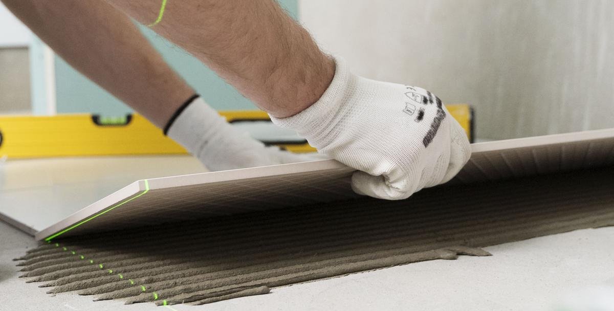 HIR tile adhesive and grout being applied on site by a professional tiler